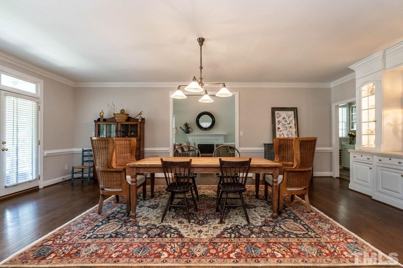 3129 Eton Road Raleigh, NC 27608 - Photo 8 of 44 a view of a dining room with furniture window and wooden floor