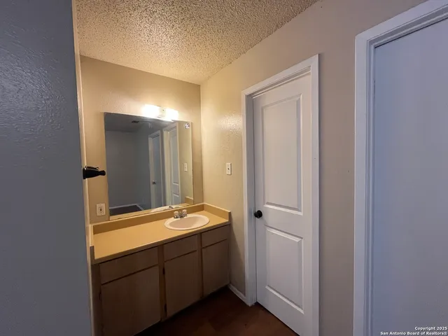 a bathroom with a sink and mirror