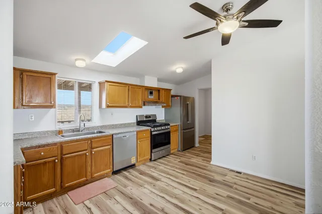 a kitchen with stainless steel appliances granite countertop a stove and a sink