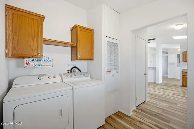 a view of a livingroom with wooden floor and a ceiling fan