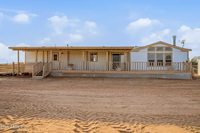 a view of a balcony with chairs and wooden floor