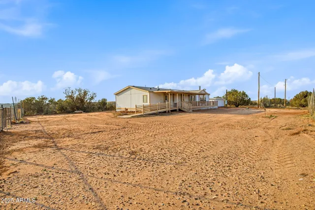 a view of wooden house with a yard
