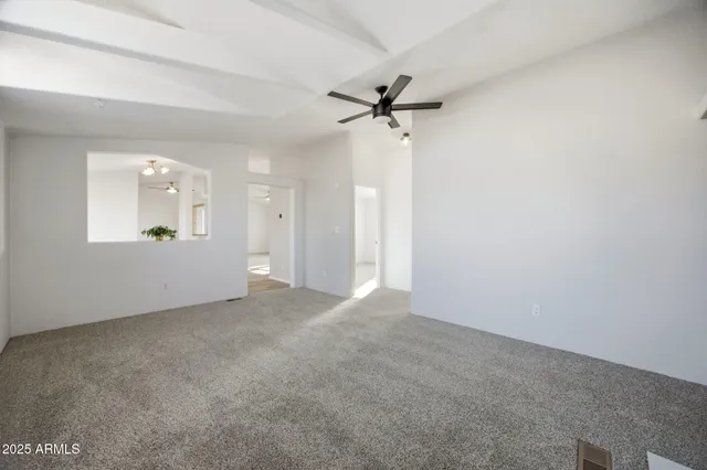 a view of an empty room with a fireplace and a window