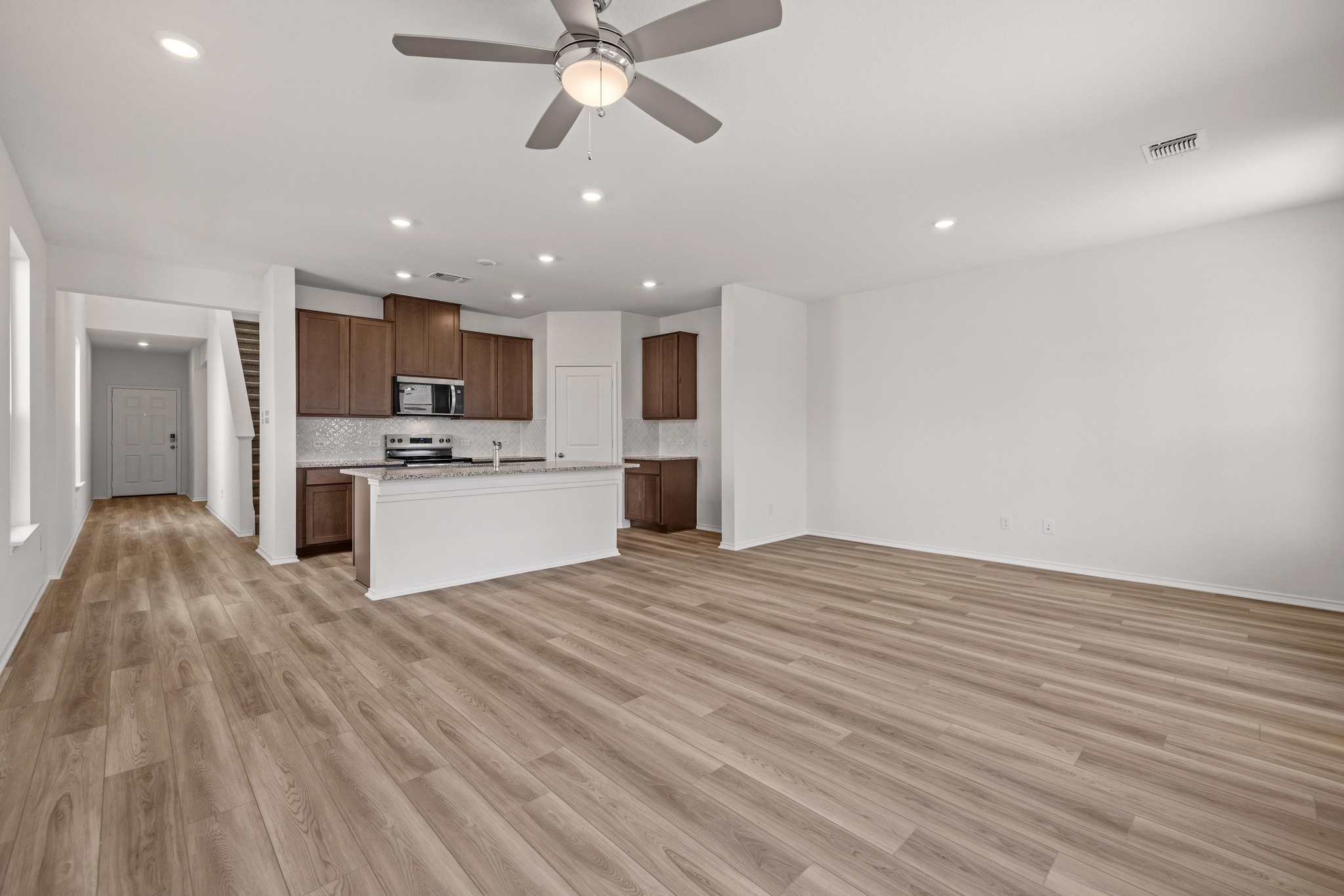 260 Feathers Street Jarrell, TX 76537 - Photo 11 of 34 a view of a kitchen with a sink and a refrigerator