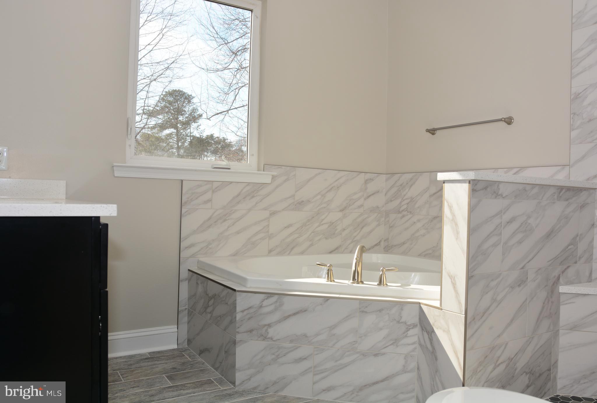 11231 Rawhide Road Lusby, MD 20657 - Photo 15 of 18 a bathroom with a bathtub and window