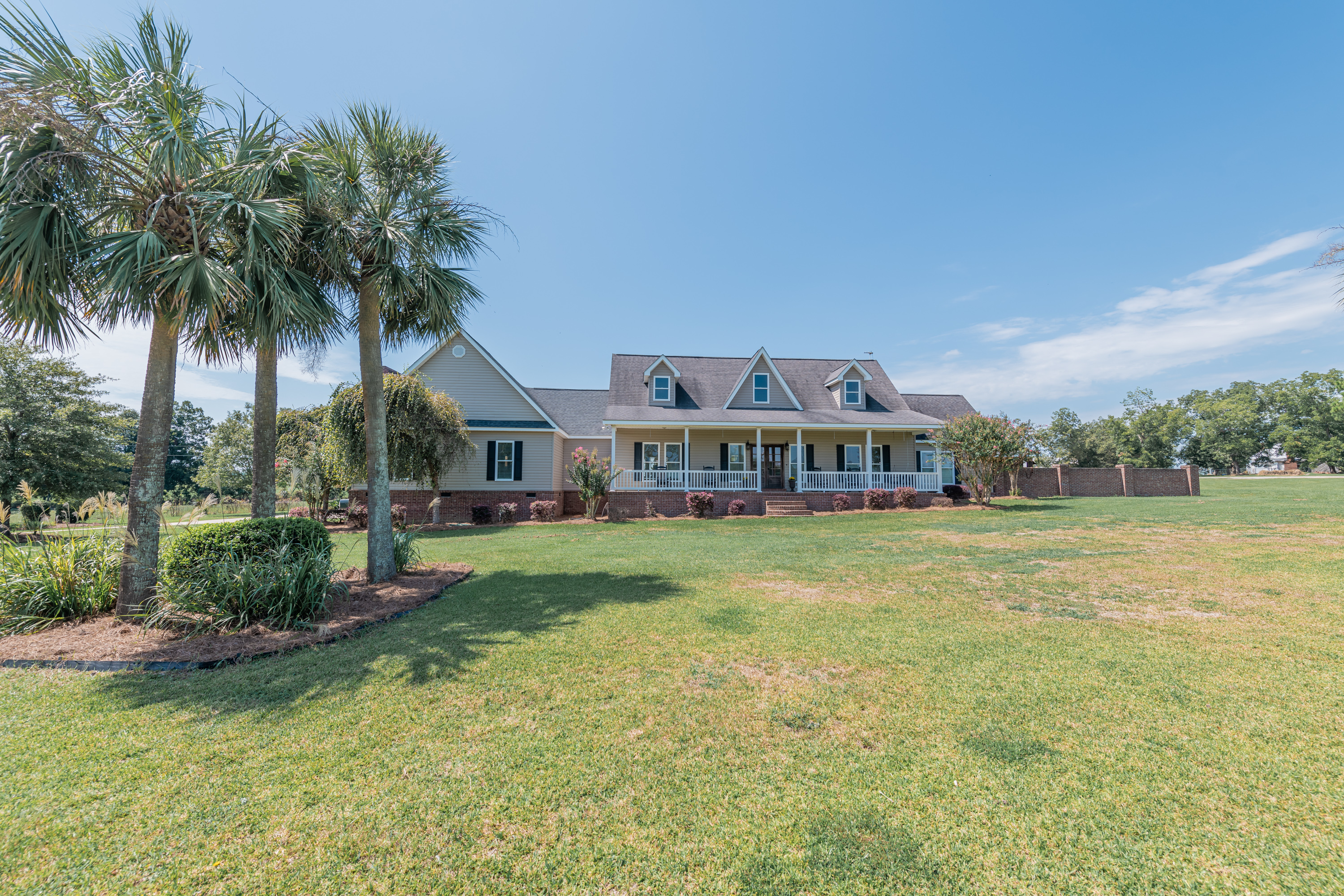 440 Dykes Burch Road Eastman, GA 31023 - Photo 1 of 1 a view of a house with a big yard and palm trees