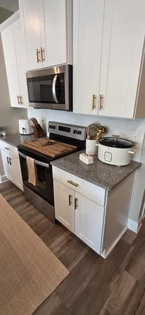 a kitchen with stainless steel appliances granite countertop a sink and a stove