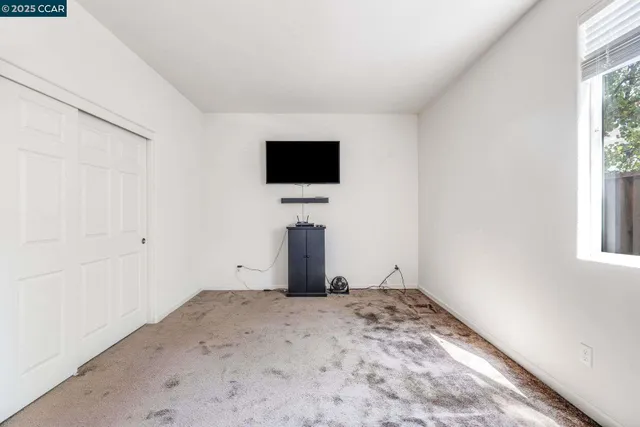 a view of a livingroom with wooden floor and a window