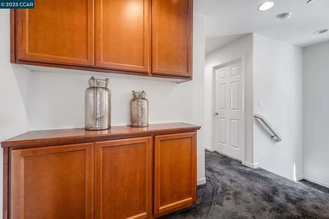 a kitchen with stainless steel appliances granite countertop a refrigerator and cabinets