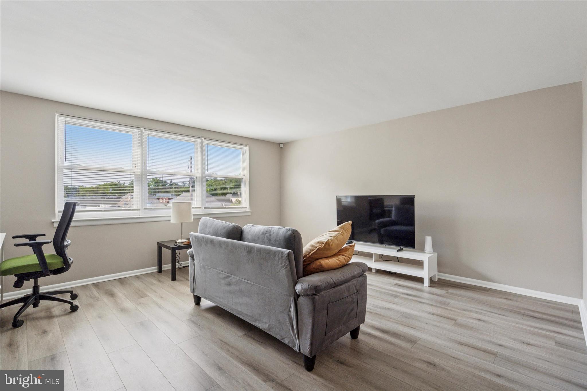 120 Clement Road Oreland, PA 19075 - Photo 14 of 34 a living room with furniture and a flat screen tv with wooden floor
