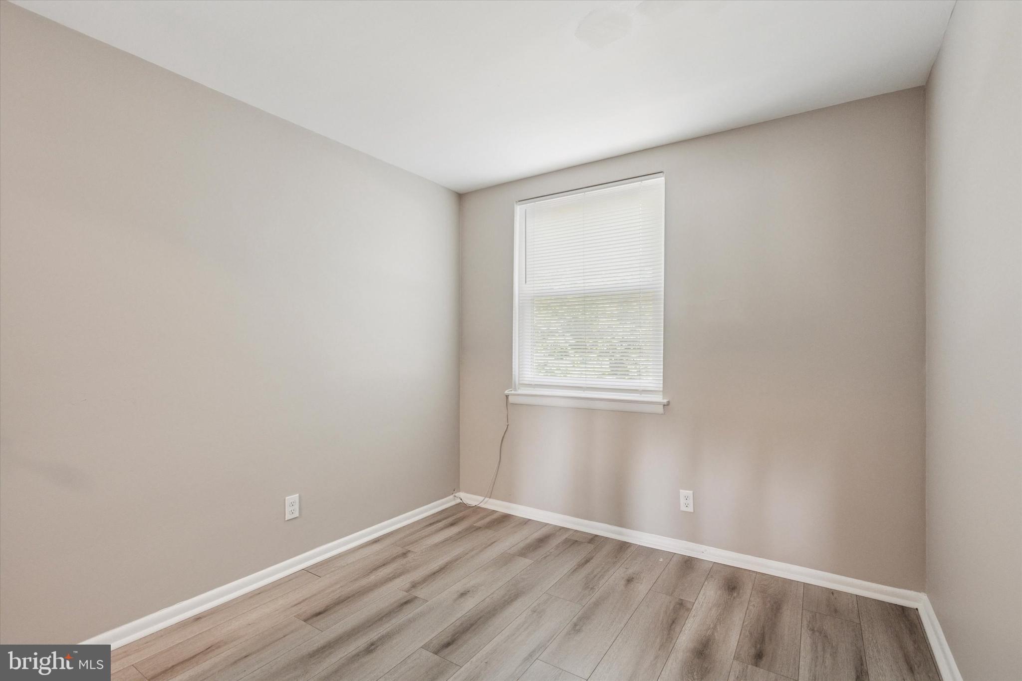 120 Clement Road Oreland, PA 19075 - Photo 21 of 34 a view of an empty room with wooden floor and a window