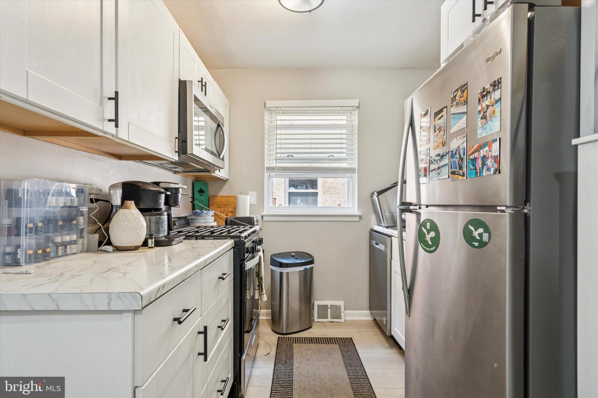 120 Clement Road Oreland, PA 19075 - Photo 5 of 34 a kitchen with stainless steel appliances granite countertop a refrigerator and a sink