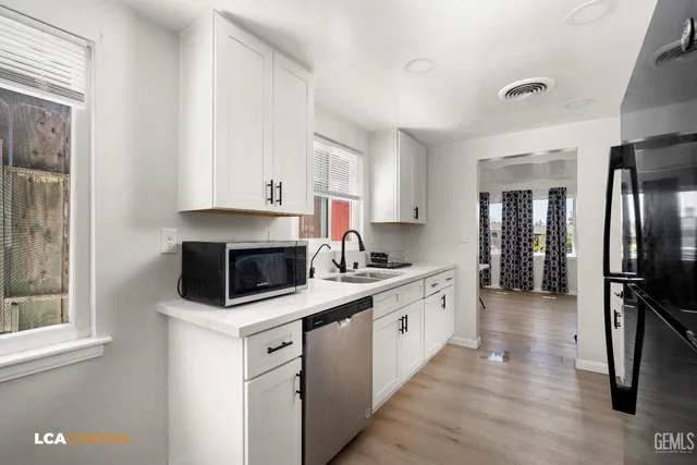 a kitchen with stainless steel appliances a stove a sink and a refrigerator