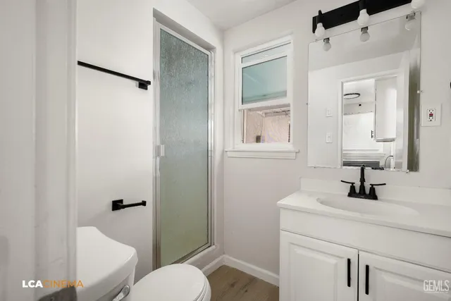 a bathroom with a toilet sink and shower