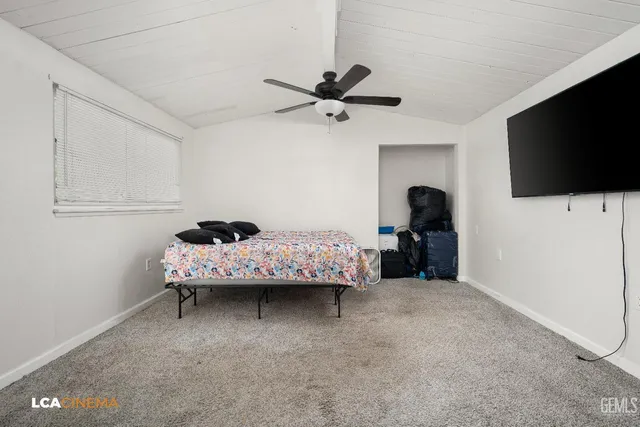 a bedroom with bed and tv