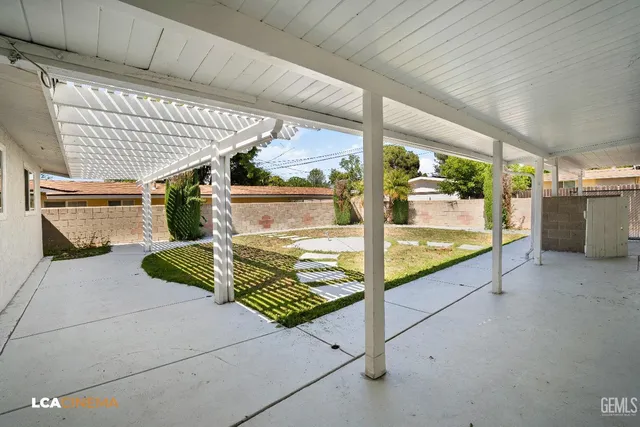 a view of a house with pool and a yard