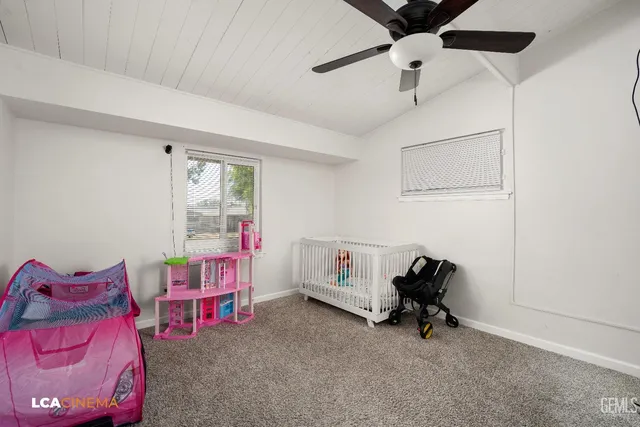 a view of a room with window a table and chairs