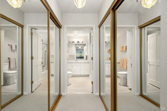 a bathroom with a glass shower door and a glass door
