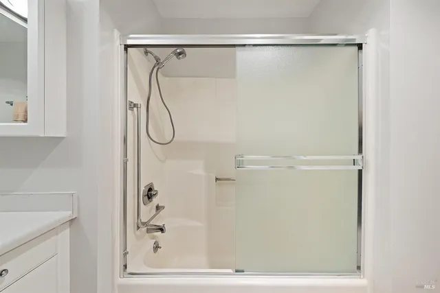 a bathroom with a glass shower door