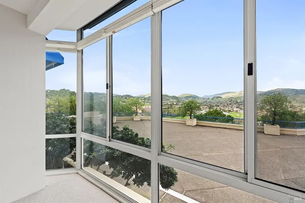 a view of a glass door and a yard from a window