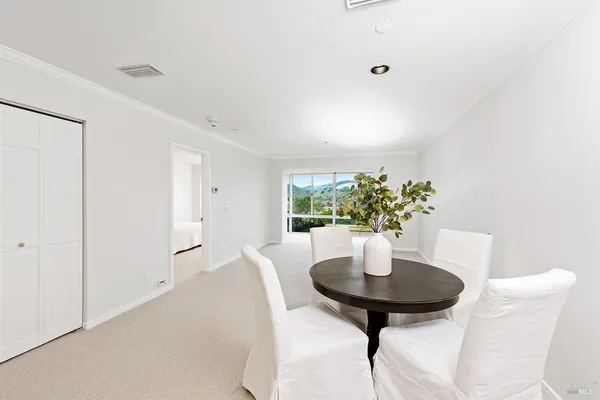 a view of a livingroom with a table and chair