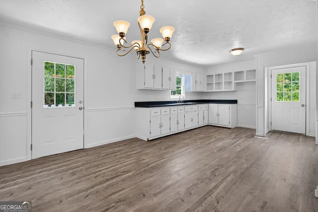 a view of a kitchen with a dishwasher cabinets and wooden floor