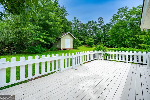 a view of wooden deck and a yard