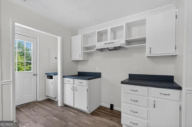 a kitchen with stainless steel appliances white cabinets and a sink