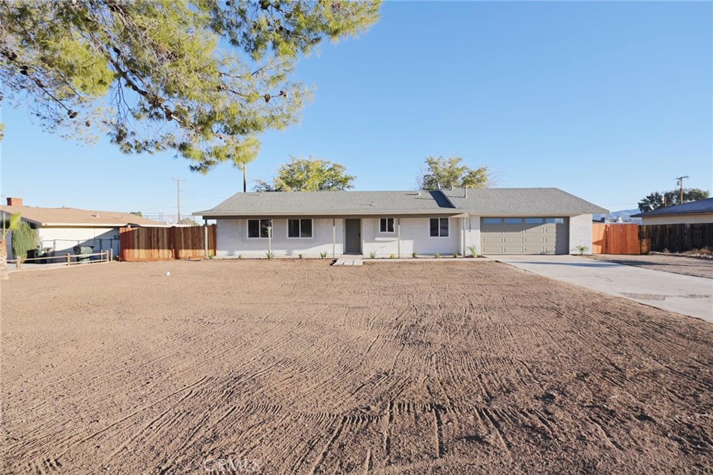 11385 Chimayo Road Apple Valley, CA 92308 - Photo 1 of 1 a front view of a house with a yard