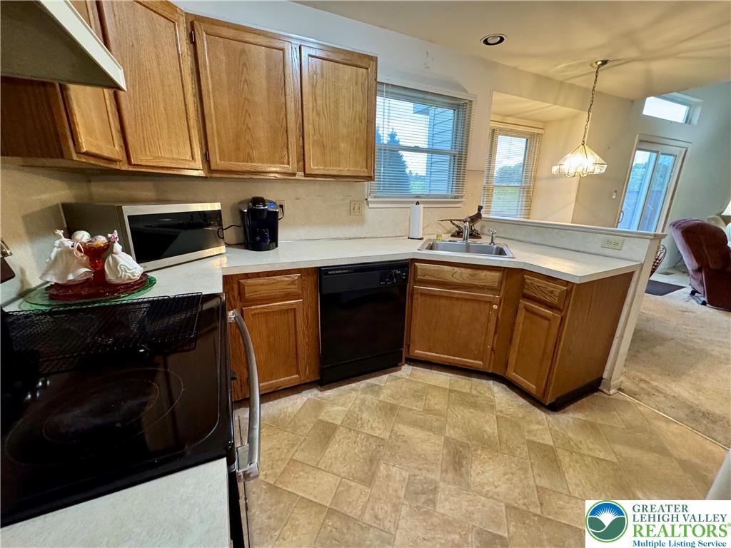 255 Ridings Circle Macungie, PA 18062 - Photo 9 of 30 a kitchen with stainless steel appliances granite countertop a sink stove and cabinets