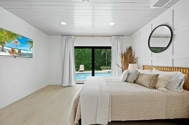 a bedroom with a bed and a large window