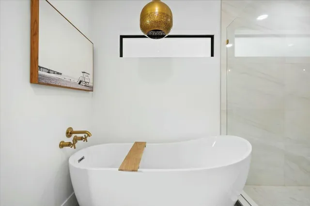 a bathroom with a tub and a shower