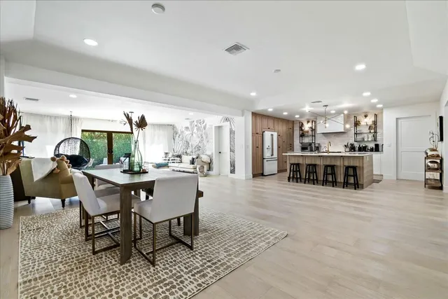 a large kitchen with a table and chairs