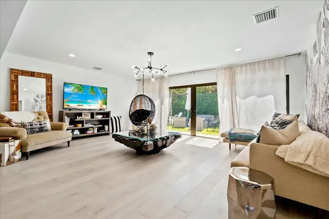a living room with furniture and a chandelier