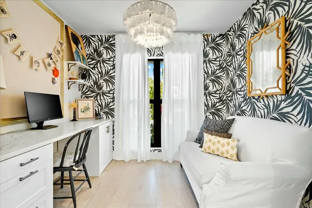 a bedroom with a bed and a chandelier