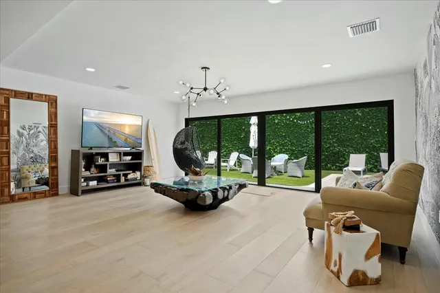 a view of a livingroom with furniture and floor to ceiling window