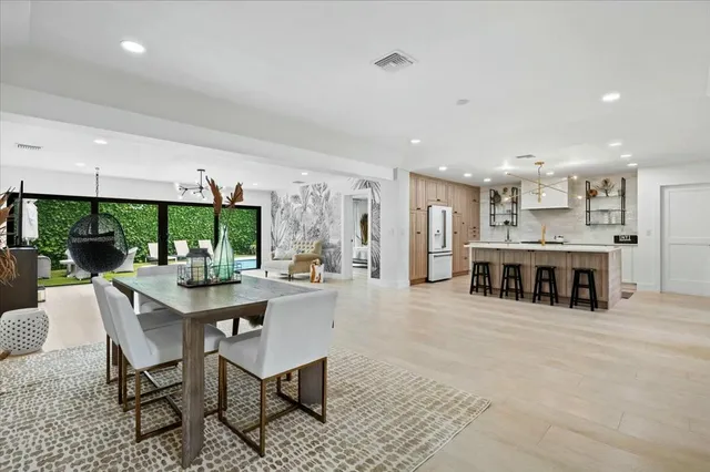 a living room with stainless steel appliances kitchen island granite countertop furniture and a large window