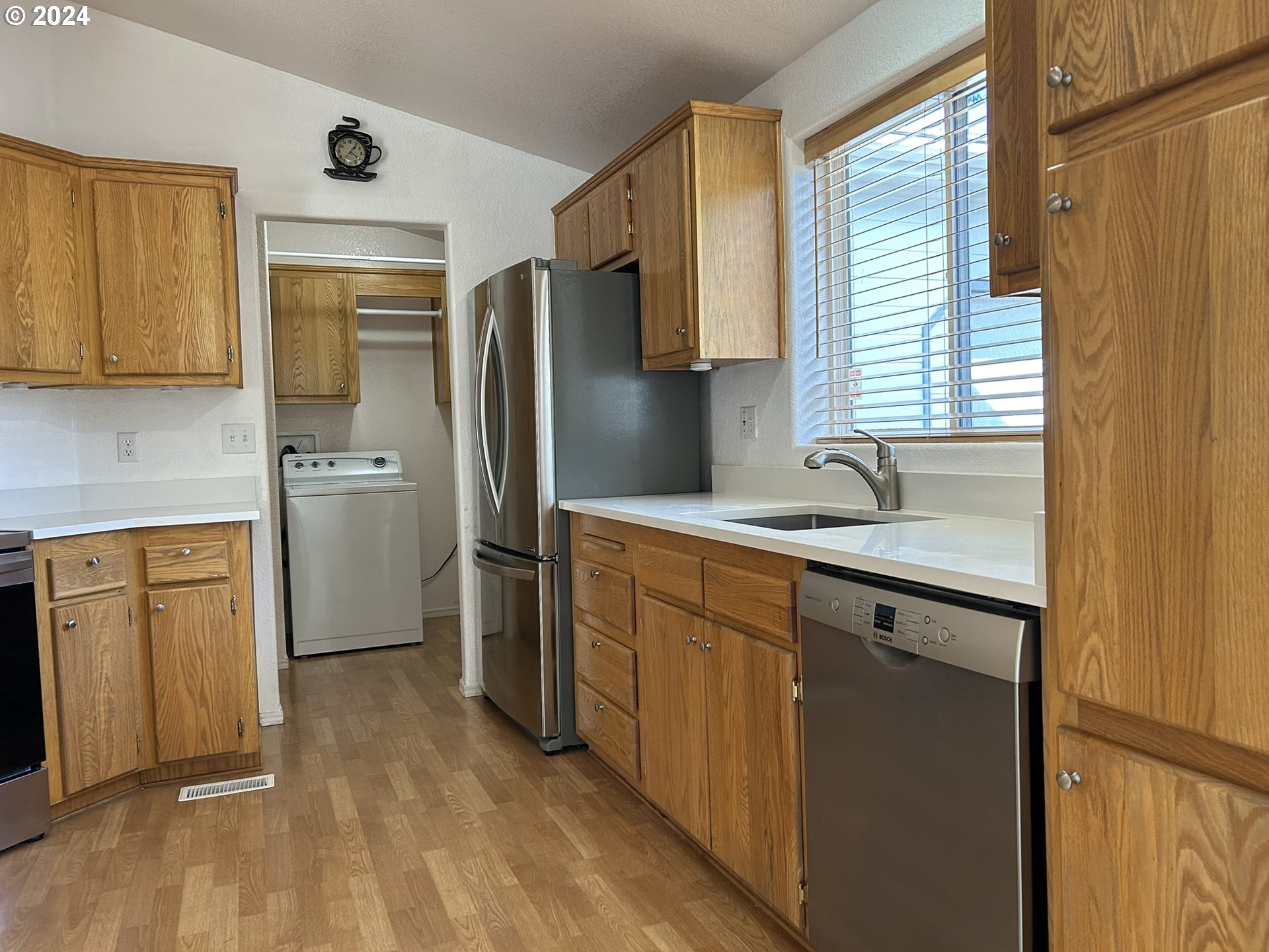 853 Munsel Creek Loop Florence, OR 97439 - Photo 12 of 44 a kitchen with a refrigerator sink and cabinets
