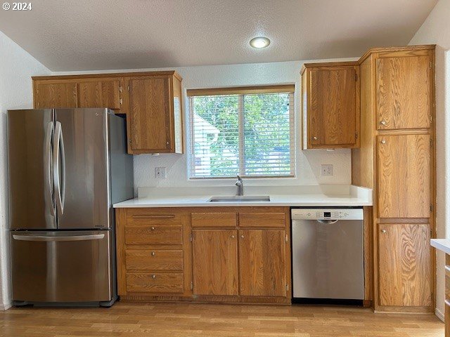 853 Munsel Creek Loop Florence, OR 97439 - Photo 13 of 44 a kitchen with a refrigerator and a sink