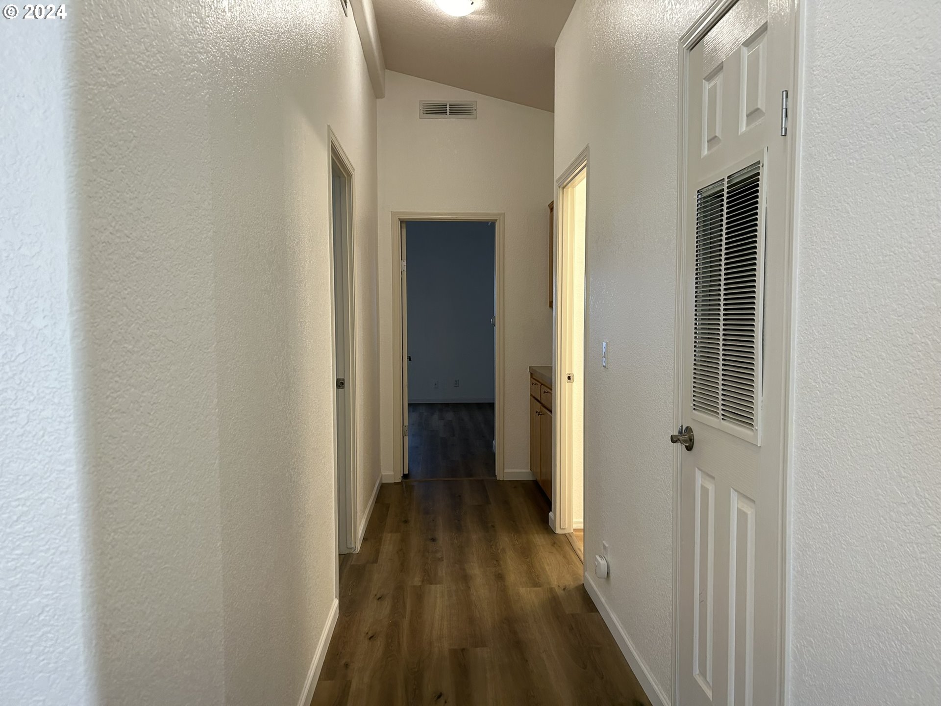 853 Munsel Creek Loop Florence, OR 97439 - Photo 19 of 44 a view of a hallway with a wooden floor