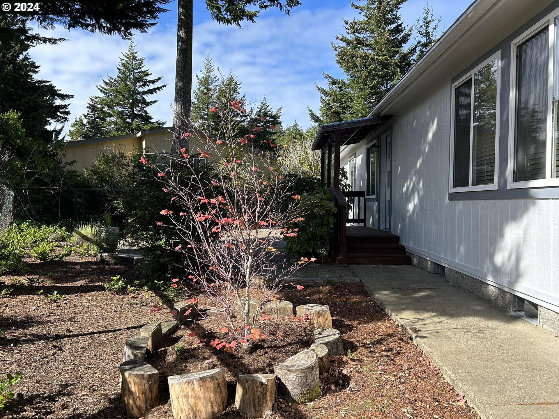 853 Munsel Creek Loop Florence, OR 97439 - Photo 30 of 44 a view of a house with a yard