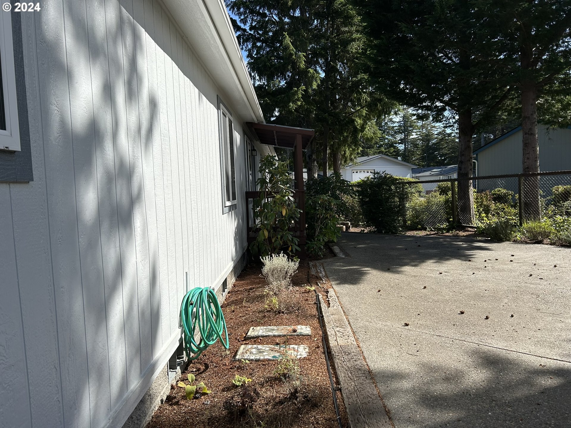 853 Munsel Creek Loop Florence, OR 97439 - Photo 32 of 44 a view of backyard with potted plants
