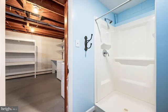 a bathroom with a bathtub and a shower