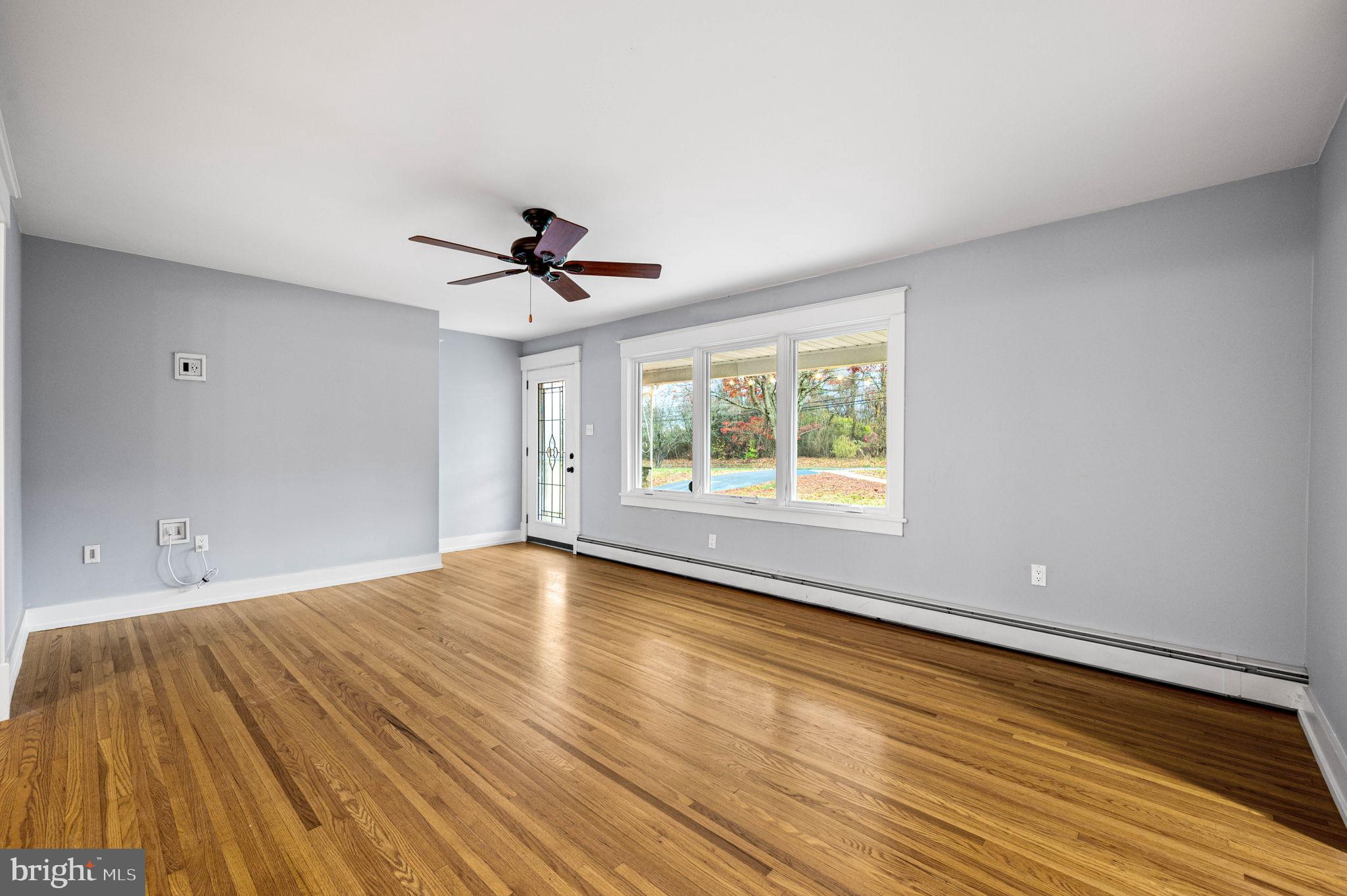 847 Highspire Road Glenmoore, PA 19343 - Photo 2 of 21 wooden floor in an empty room with a window