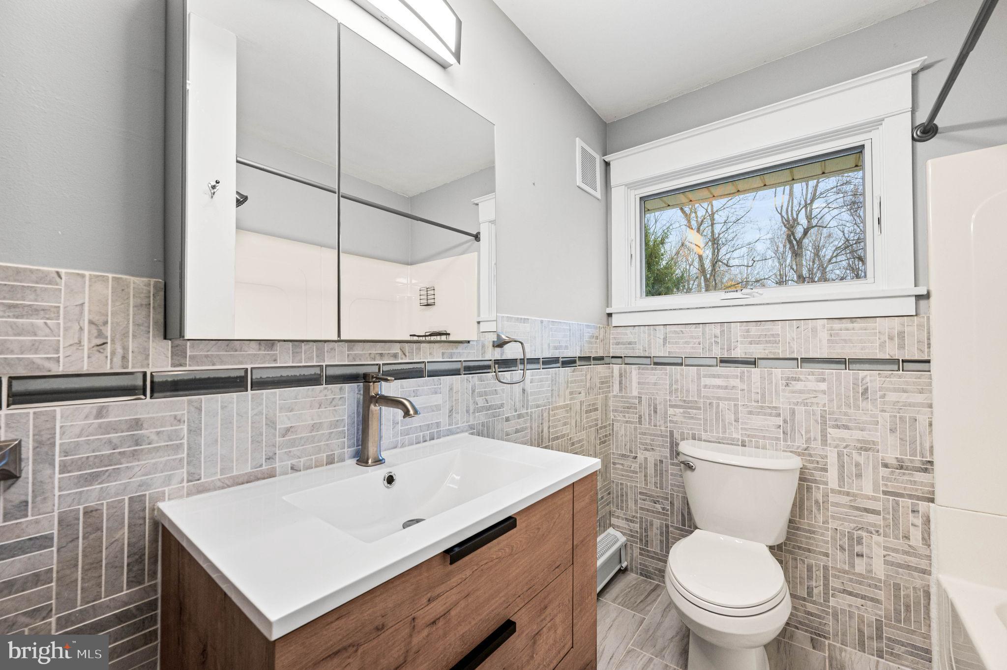 847 Highspire Road Glenmoore, PA 19343 - Photo 8 of 21 a bathroom with a sink a toilet and a window