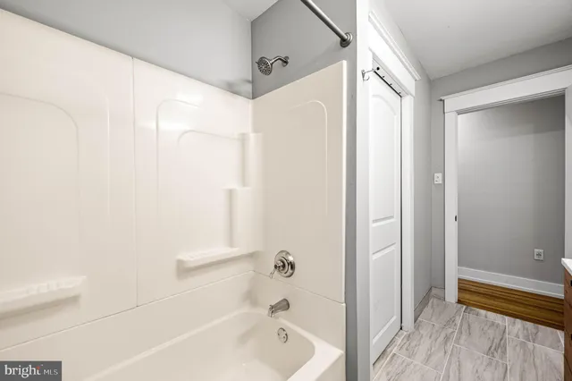 a bathroom with a bathtub and a shower