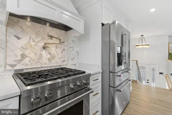 a stove top oven sitting inside of a kitchen
