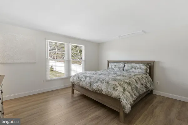 a large bed sitting in a bedroom next to a window