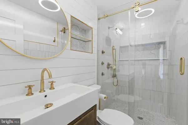 a bathroom with a sink toilet and shower