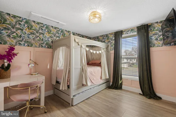a view of a livingroom with wooden floor and a window